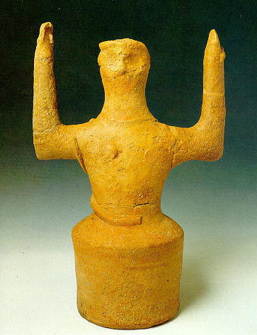 clay figurine with upraised arms