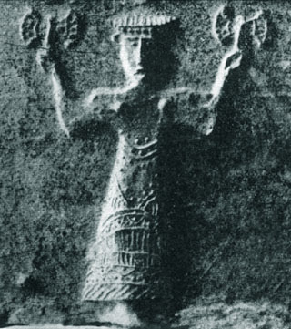 a stone mold with relief of goddess holding double axes