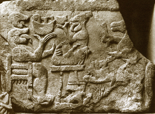 carved stone relief of animals banqueting