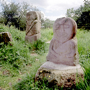 two stone statues in archaic style