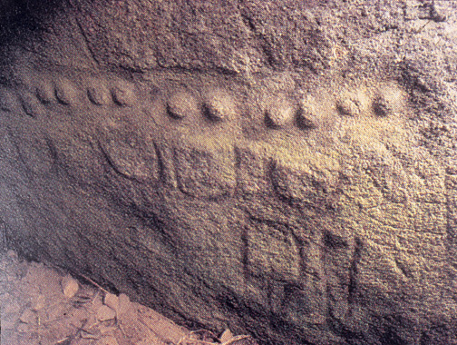 pairs of female breasts carved into rockface